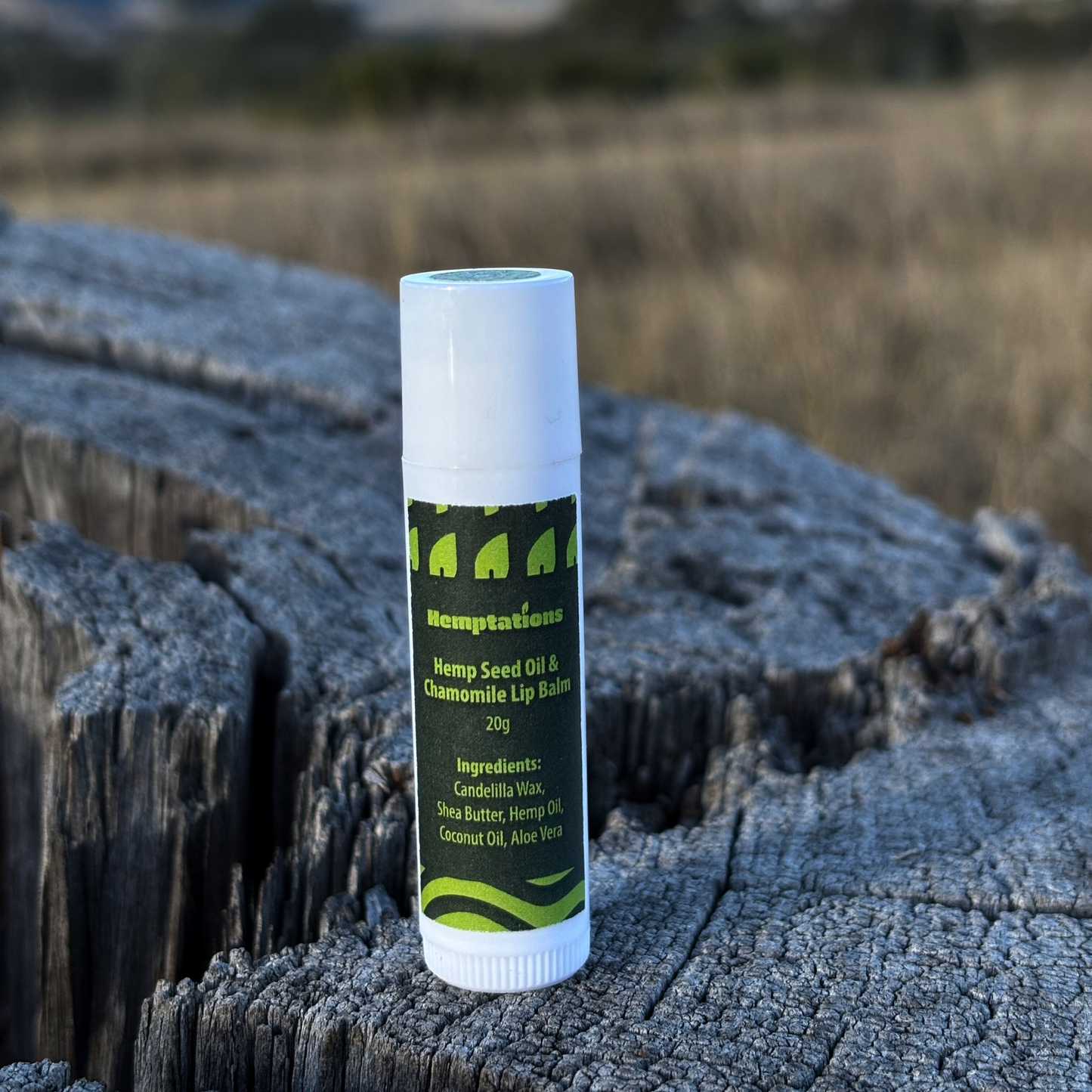 Lip balm tube on a wooden surface with a natural background