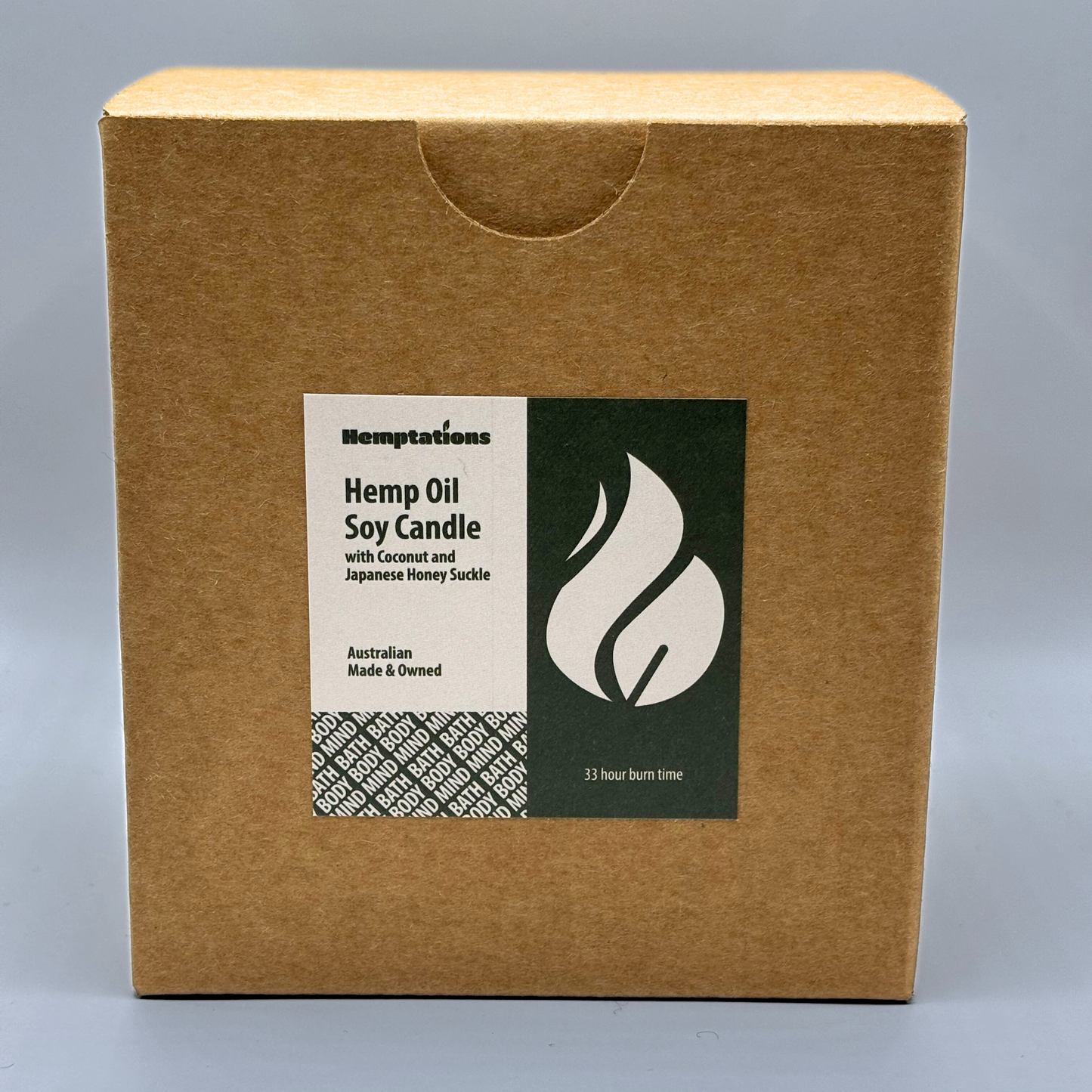Hemptations Hemp Oil Soy Candle packaging with a label on a gray background