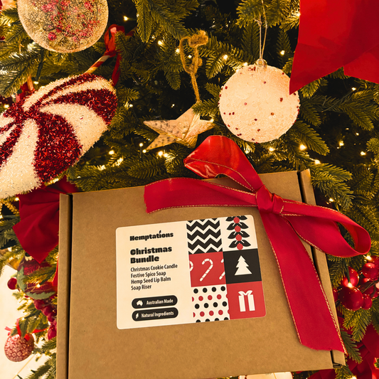 Hemptations Christmas Bundle with a red bow on a decorated Christmas tree.