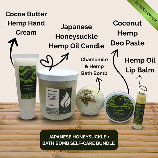 Collection of self-care products including cocoa butter hemp hand cream, Japanese honeysuckle hemp oil candle, coconut hemp deo paste, chamomile and hemp bath bomb, and hemp oil lip balm on a bamboo surface.